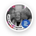 A smiling elderly woman is kissed on both cheeks by two younger women. A sticker reads 